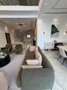 a living room with a couch and a table at La villa Bella Vista in Somone