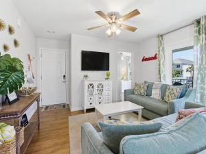 a living room with two couches and a tv at Beachside Villas #821 - Dreamweaver in Seagrove Beach