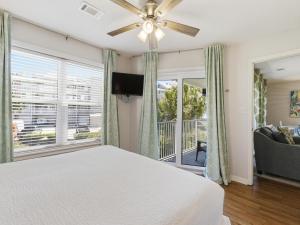 a bedroom with a bed and a large window at Beachside Villas #821 - Dreamweaver in Seagrove Beach