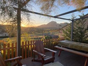 a wooden deck with a bench and a fence at Maison de Coco in LʼÉpine +11 photos