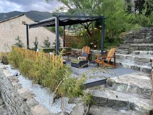 a patio with a gazebo and a table and chairs at Maison de Coco in LʼÉpine