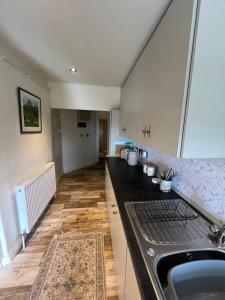 a kitchen with a sink and a counter top at Carrick Cottage - Mourne Mountains in Annalong