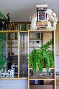 a shelf with a vase and a plant on it at Apartmán Brezy in Martinske Hole
