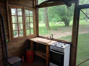 an outdoor kitchen with a stove and a window at Le chalet de Montestrucq in Montestrucq