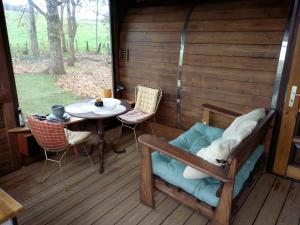 a porch of a cabin with a table and chairs at Le chalet de Montestrucq in Montestrucq