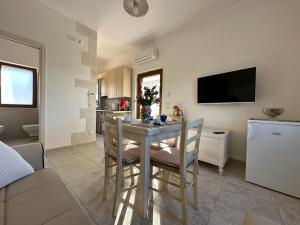 a kitchen and dining room with a table and chairs at Trullo Cuore di Pietra in Locorotondo