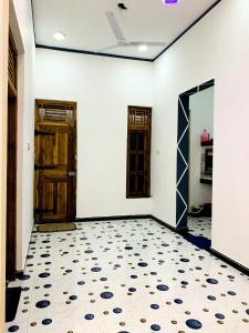 an empty room with two doors and a tiled floor at Dream Mahal in Kattankudi