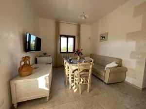 a living room with a couch and a table at Trullo Cuore di Pietra in Locorotondo