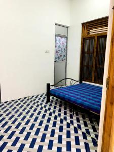 a bed in a room with a blue mattress at Dream Mahal in Kattankudi