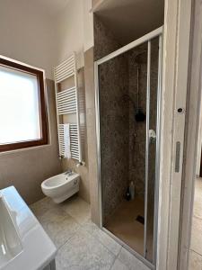 a bathroom with a shower and a toilet and a sink at Trullo Cuore di Pietra in Locorotondo +26 photos