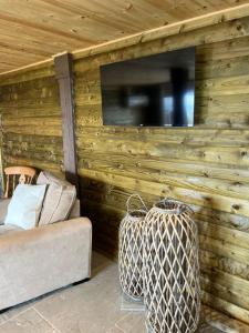 a suitcase sitting in front of a wall with a tv at Carrick Cottage - Mourne Mountains in Annalong +23 photos