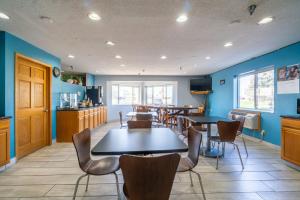 a room with tables and chairs and a kitchen at Days Inn by Wyndham Sioux City in Sioux City