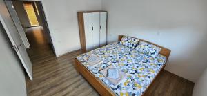 a small bed in a room with a door at Ira's Square 2 Bedroom Free Parking in Skopje