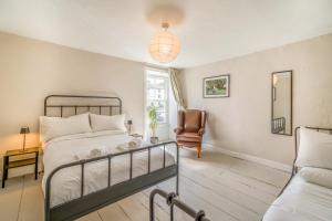 a bedroom with a bed and a chair at Forge End Cottage Middleham in Middleham