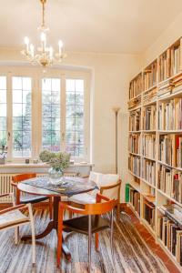 a dining room with a table and bookshelves at Villa dei Muralti - Homestay - Rooms rental in Muralto