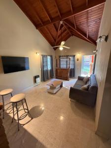 a living room with a couch and a flat screen tv at Casa Guemes in Merlo