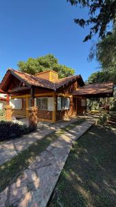 a house with a pathway in front of it at Casa Guemes in Merlo