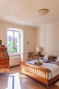 a bedroom with a large bed and a window at Villa dei Muralti - Homestay - Rooms rental in Muralto +117 photos