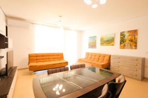 a living room with a couch and a table at SanPietro Apartments in Draç