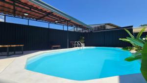 a swimming pool in the backyard of a house at Mango Coliving Apartments for Digital Nomads in Uvita