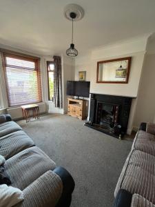 a living room with a couch and a fireplace at Ivanhoe Home from Home in Freshwater
