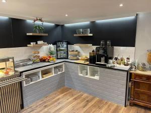 a kitchen with a counter with food on it at Hotel Birnbaum in Ansbach