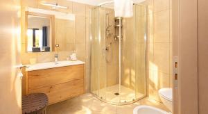 a bathroom with a shower and a sink and a toilet at Kalispera Rooms in Scalea +24 photos