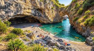 a group of people on a beach in a cave at Kalispera Rooms in Scalea
