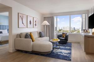 a living room with a couch and a bed at The Sunny in Sunny Isles Beach