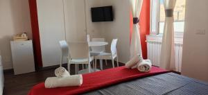 a bedroom with a bed with towels on a red blanket at Appartamenti Mergellina in Naples