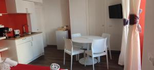 a small kitchen with a white table and chairs at Appartamenti Mergellina in Naples
