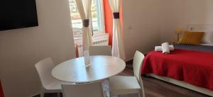 a table and chairs in a room with a bed at Appartamenti Mergellina in Naples +74 photos