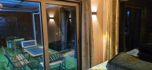 a screened in porch with a table and chairs at Green Discovery's Birds' Nests in Henrietta