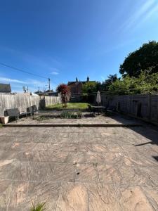 a patio with a fence and a table and chairs at Ivanhoe Home from Home in Freshwater