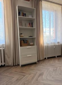 a white book shelf in a room with a window at Ferienwohnung Börnecker Landruhe in Börnecke