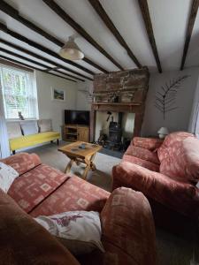 a living room with a couch and a table at Brook cottage in Brayton Station