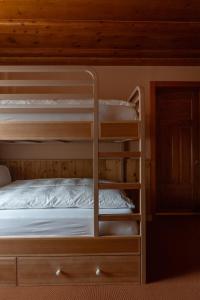 a bunk bed with a ladder towered over a bed at Boutique Hotel Engadinerhof - A Home for Generations in Pontresina