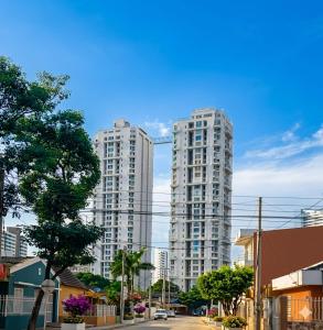 two tall white apartment buildings in a city at Cartagena Flat Resort in Cartagena de Indias