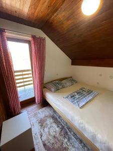 a small bedroom with a bed and a window at Vintage house Jablanica Lake in Železnička Stanica Jablanica Grad
