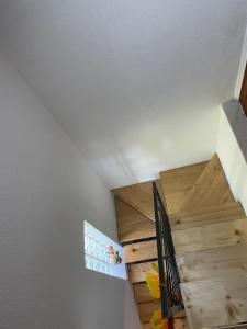 a staircase in a house with a wooden ceiling at Vintage house Jablanica Lake in Železnička Stanica Jablanica Grad +3 photos