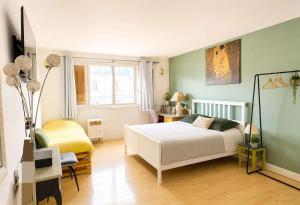 a bedroom with a white bed in a room at Spacious Studio Paris La villette-Metro in Paris