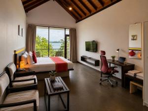 a hotel room with a bed and a desk and a couch at Zen Koggala by Sugar Coliving in Habaraduwa Central