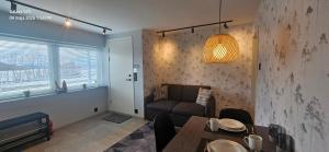 a living room with a table and a couch at Ramfjord Apartment 2 in Tromsø