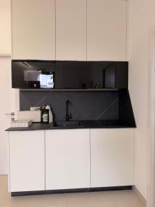 a kitchen with white cabinets and a sink at El Rincón in Pozoblanco +13 photos
