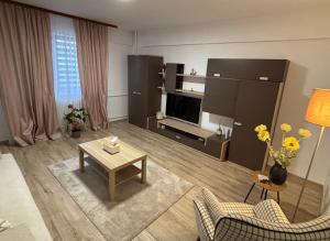 a living room with a couch and a table at Sunny Apartment in Constanţa