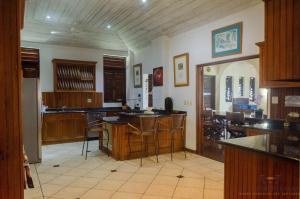 a kitchen with wooden cabinets and a table and chairs at Villa Azulejo in Black Rock