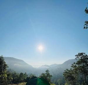 a tent on a hill with a view of a valley at Sinharaja Eco Camp in Deniyaya