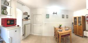 a kitchen and dining room with a table and a red tv at CiroMenotti62 in Marina di Carrara
