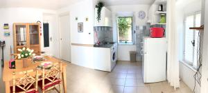 a kitchen with a table and a refrigerator at CiroMenotti62 in Marina di Carrara