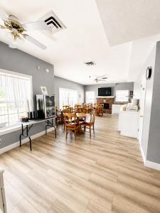 a living room with a table and a dining room at Carriage House Inn in Branson